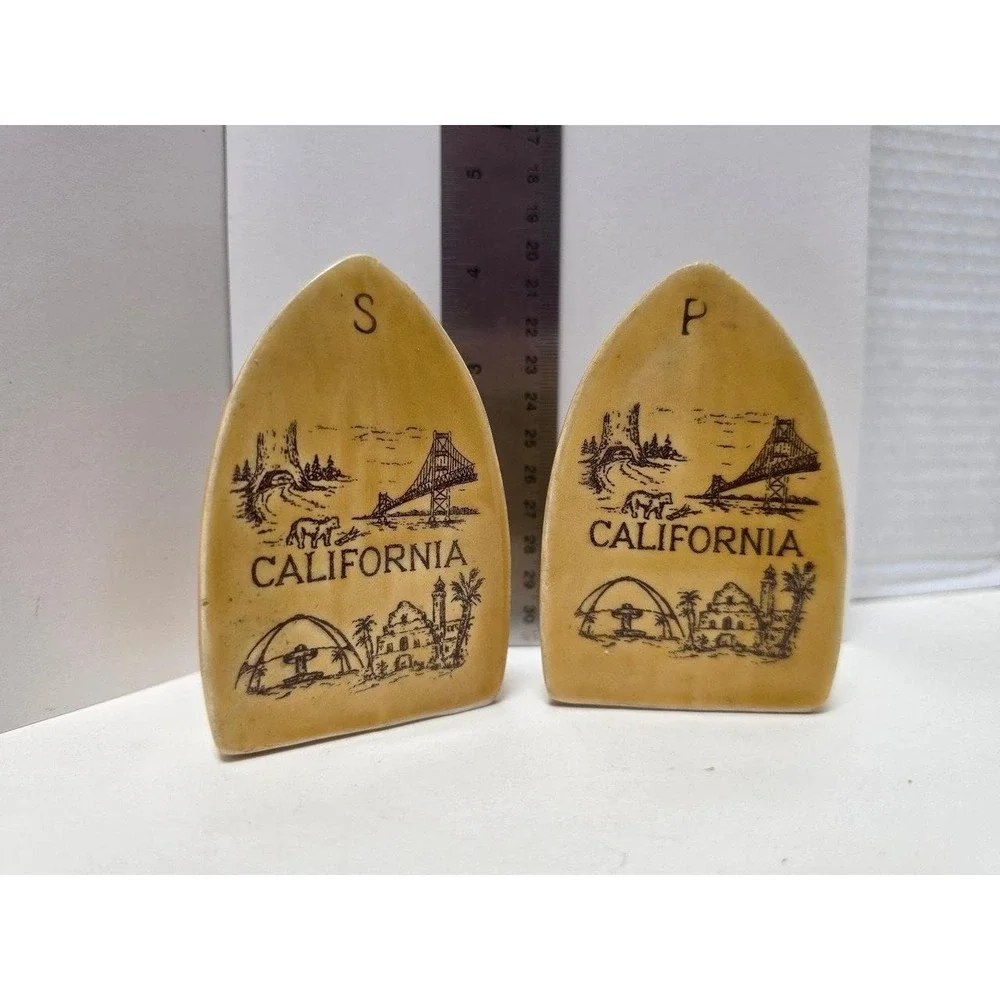 vintage souvenir salt and pepper shakers like marigold yellow iron